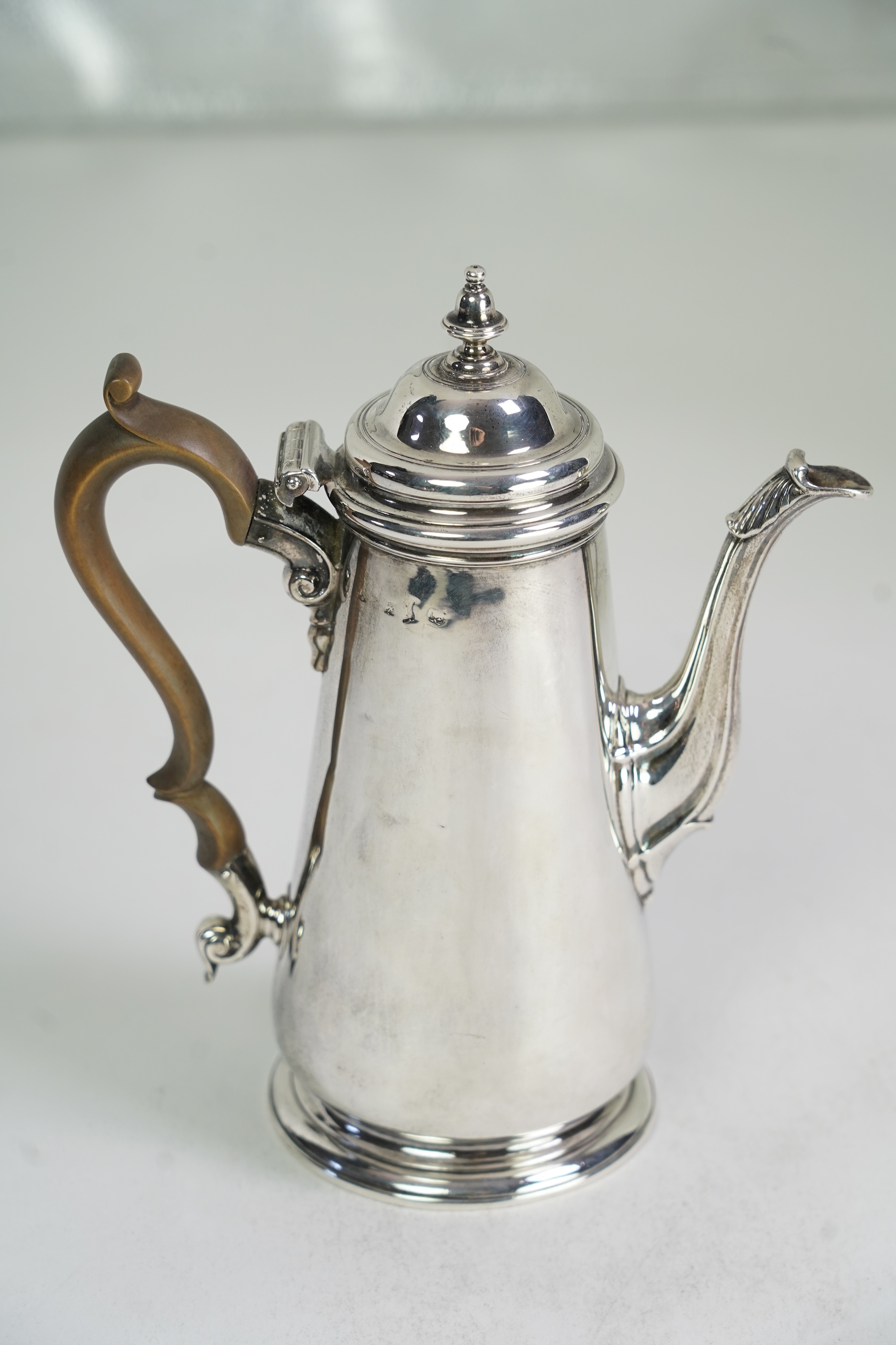 A mid 18th century silver coffee pot, marks very rubbed